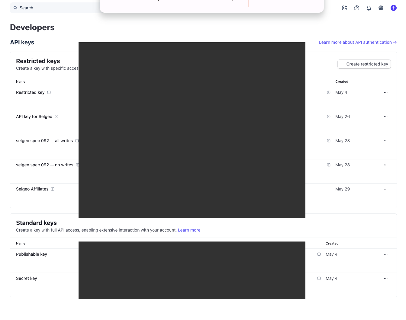 Stripe API keys list with the newly created restricted key visible at the top of the Restricted keys table.